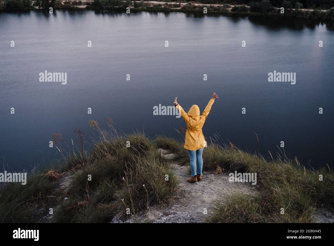 Woman wearing yellow raincoat hi-res stock photography and images - Alamy