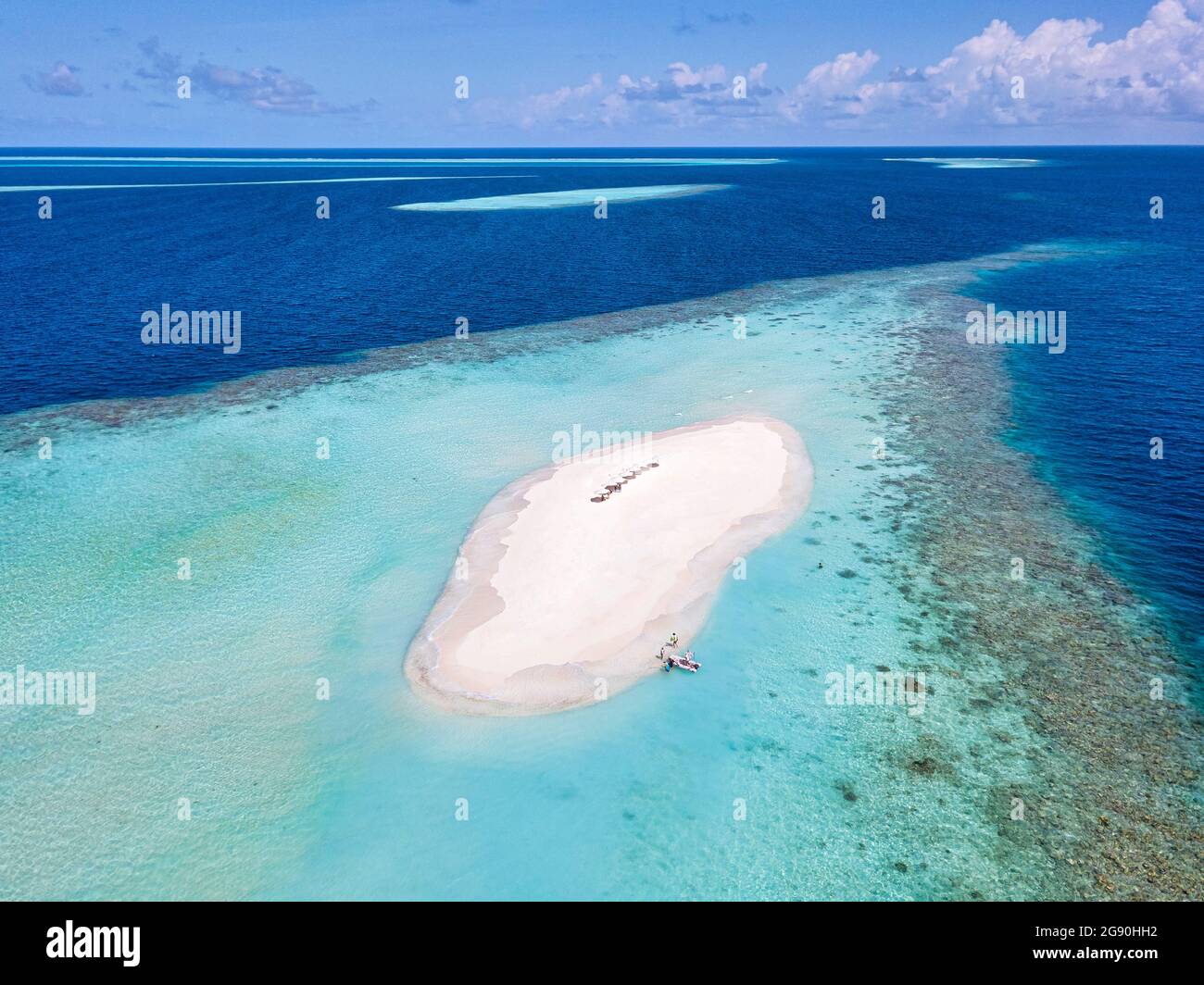 Sandy Islets Aerial view of beach umbrellas on small sandy islet off coast of Indian ...