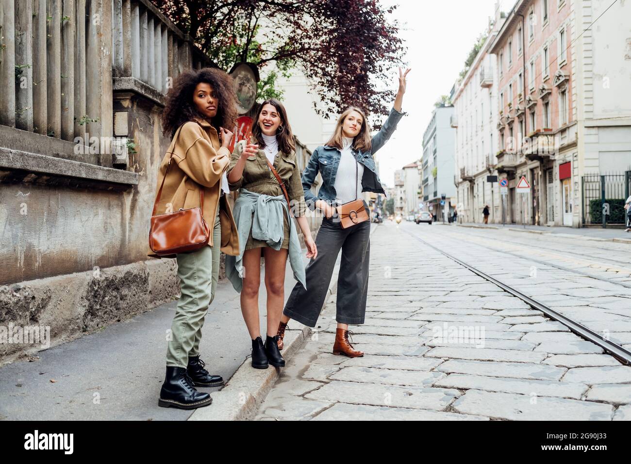 Friends standing street waving hi-res stock photography and images - Alamy