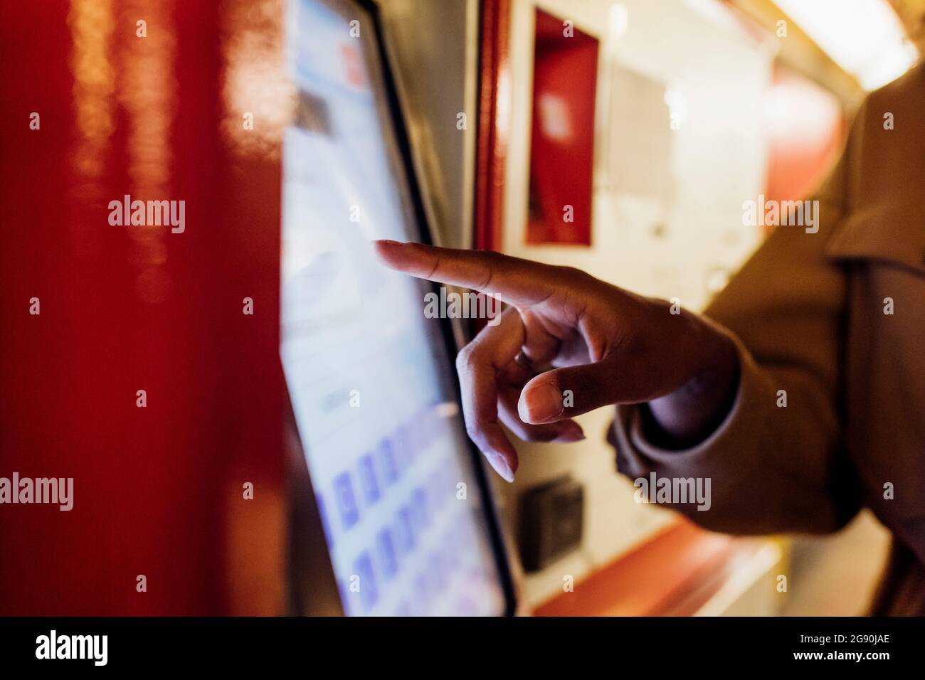 Woman using ticket machine at subway station Stock Photo - Alamy