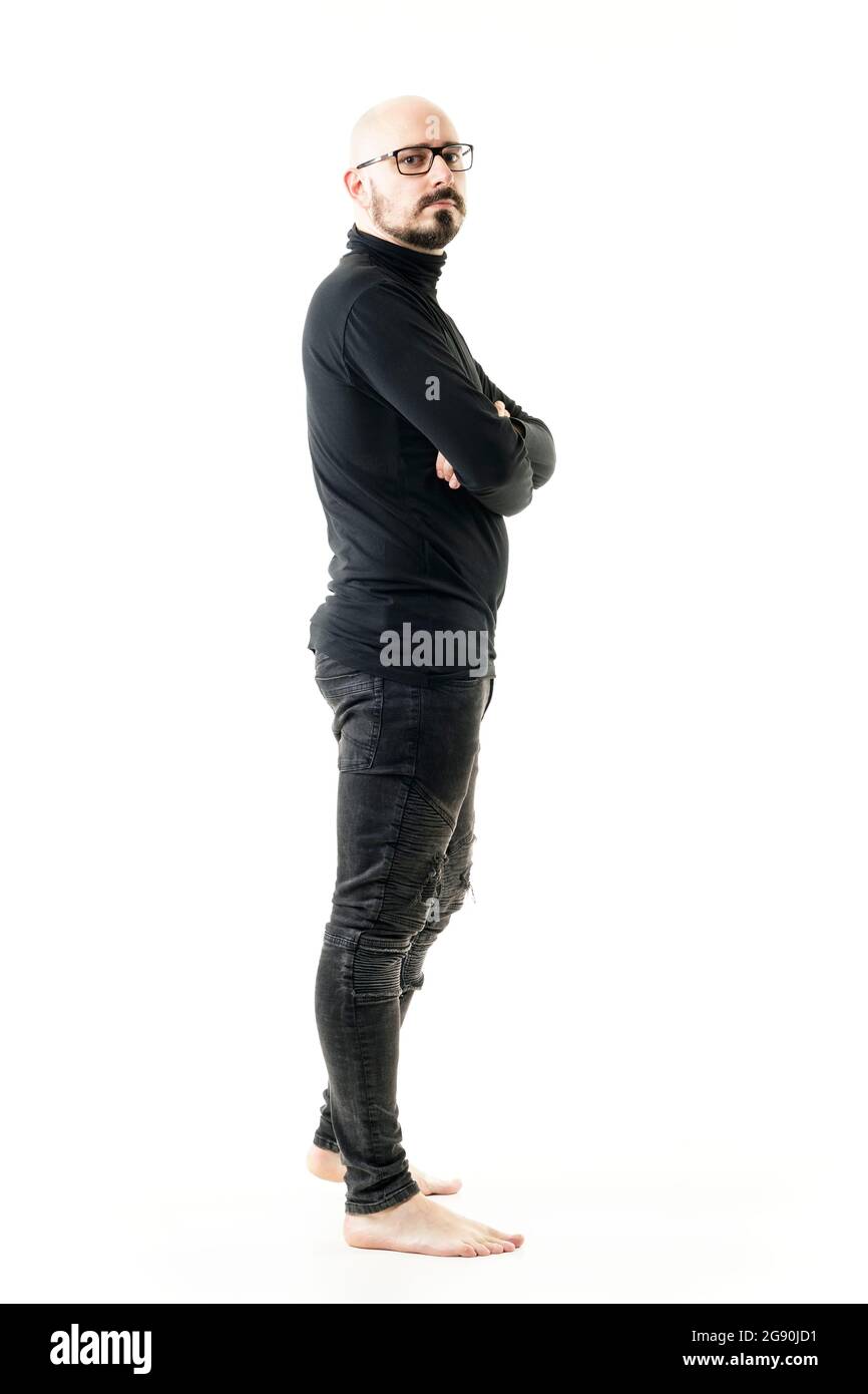 Side View Of Confident Offbeat Bald Barefoot Man In Black Clothes With 