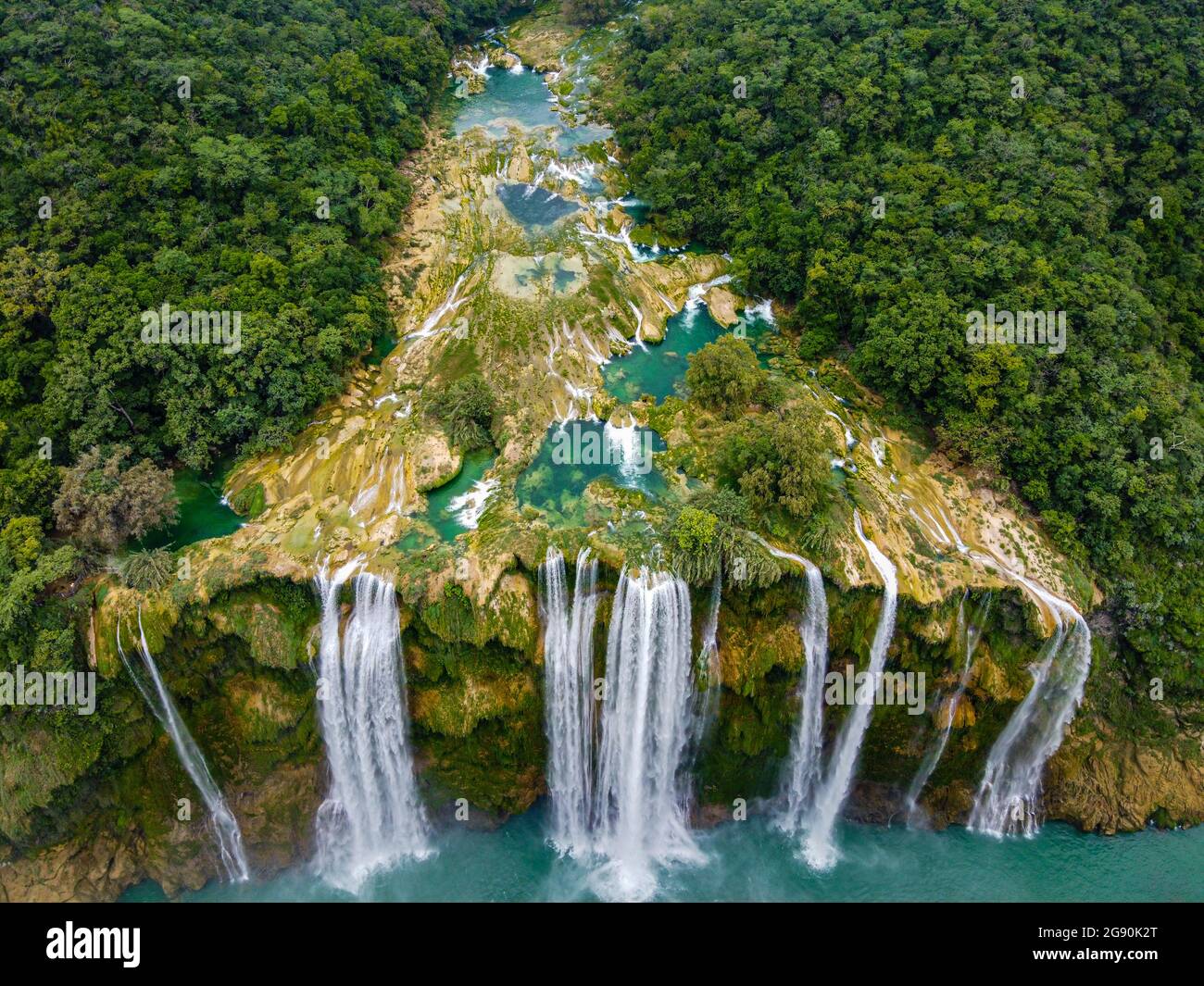 Aerial view of waterfall from rock formation amidst green trees, Huasteca Potosi, Mexico Stock Photo