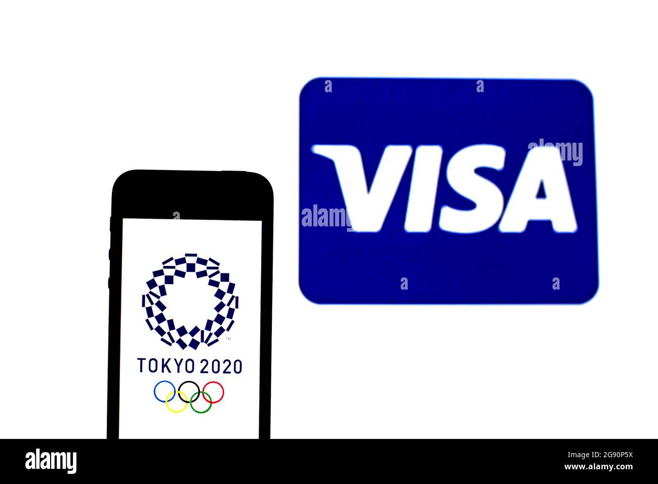 In this photo illustration a Tokyo 2020 Olympic Games logo seen displayed on a smartphone with a Visa logo in the background. Stock Photo