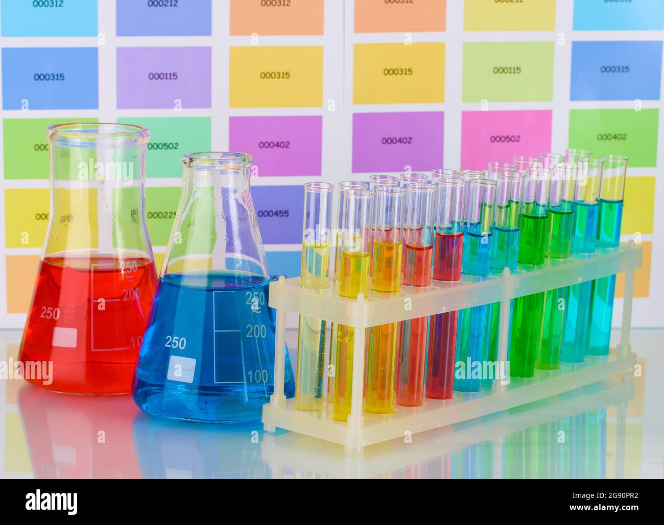 Test-tubes and flasks with color liquid on color samples background ...