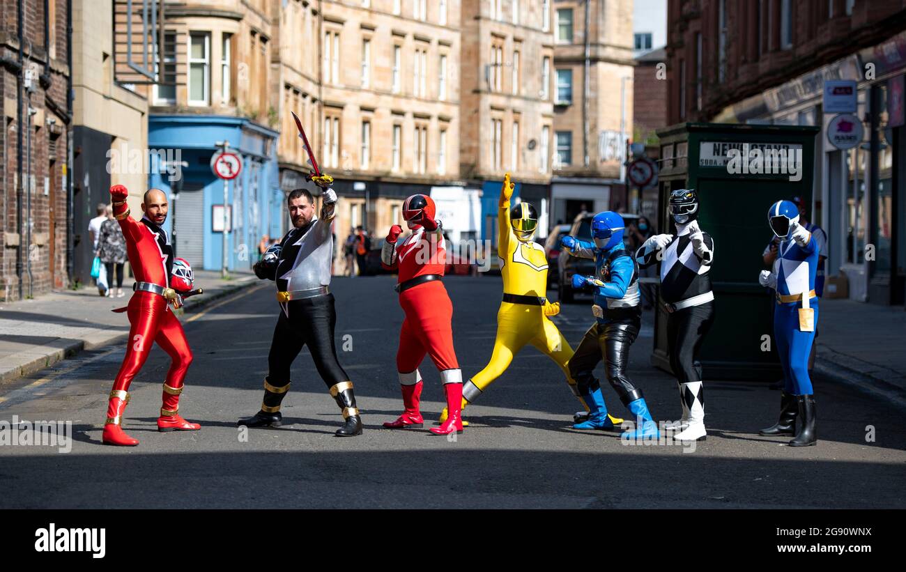 Glasgow, Scotland, UK. 23rd July, 2021. PICTURED: Power Rangers move into town as the Indiana Jones 5 movie set filming moves out. Seen in the Merchant City district of Glasgow city centre on one of the hottest days of the year, the people who are under the power rangers suits must be sweltering in the afternoon heat. The Power Ranger group go round hospitals in Glasgow and do charity work putting smiles on everyones faces. Credit: Colin Fisher/Alamy Live News Stock Photo