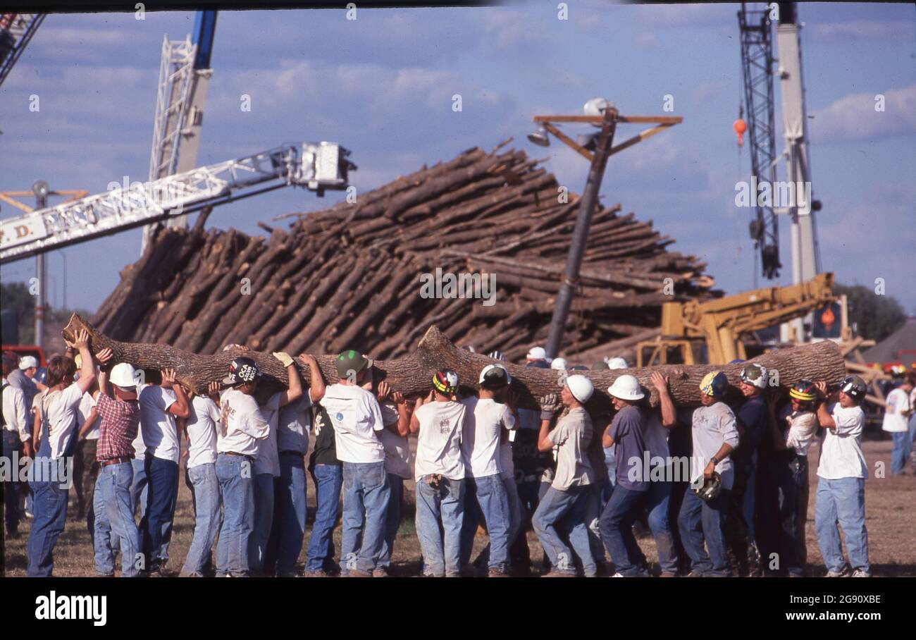College Station Texas USA, November  18 1999: Students and other volunteers remove logs from the huge piles of timber just hours after the Aggie Bonfire collapse that killed 12 people building the stacks. Bonfire is a student-led ritual at the campus that has been part of school spirit activities leading up to the annual Texas-Texas A&M football game for decades. ©Bob Daemmrich Stock Photo