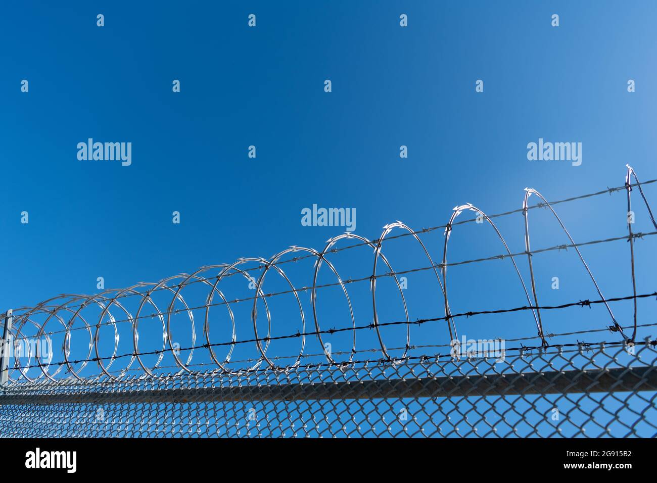 barbwire prison wall with barbed wire fence coiled razor wire perimeter