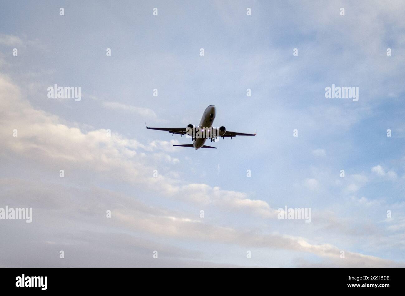 landing aircraft from below in the evening Stock Photo