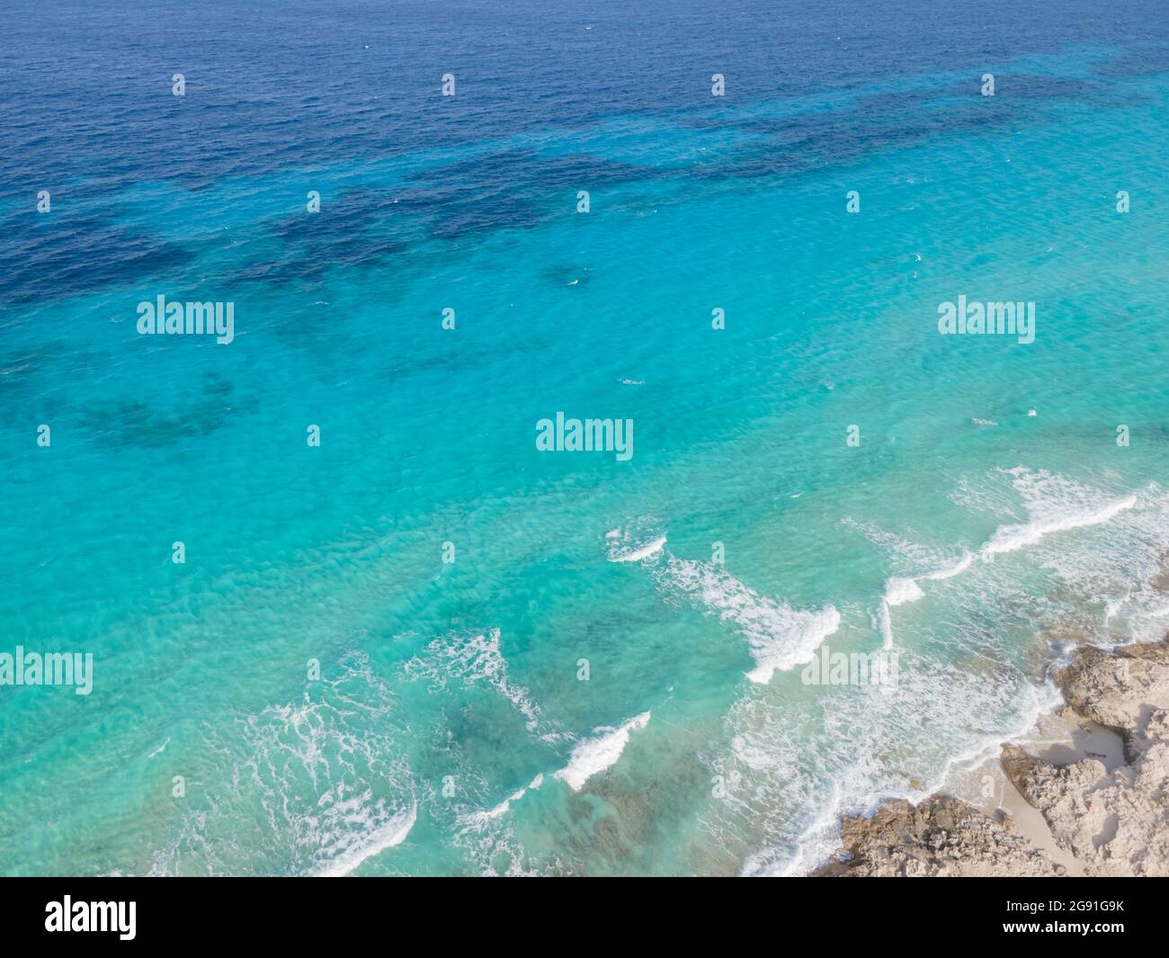 Aerial view of Ibiza, Spanish coast with white foamy waves on the ...