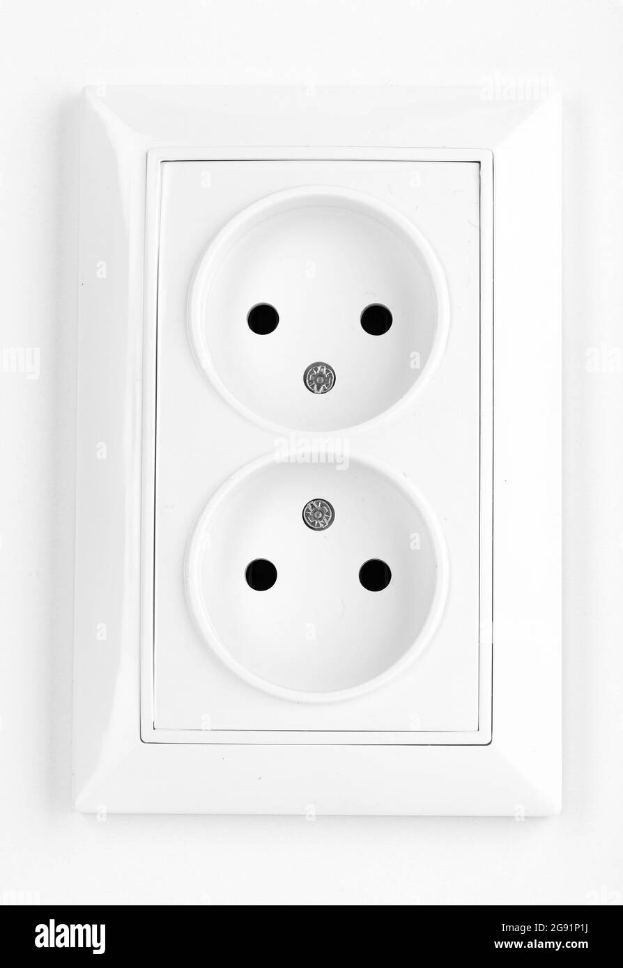White electric socket on the wall Stock Photo Alamy