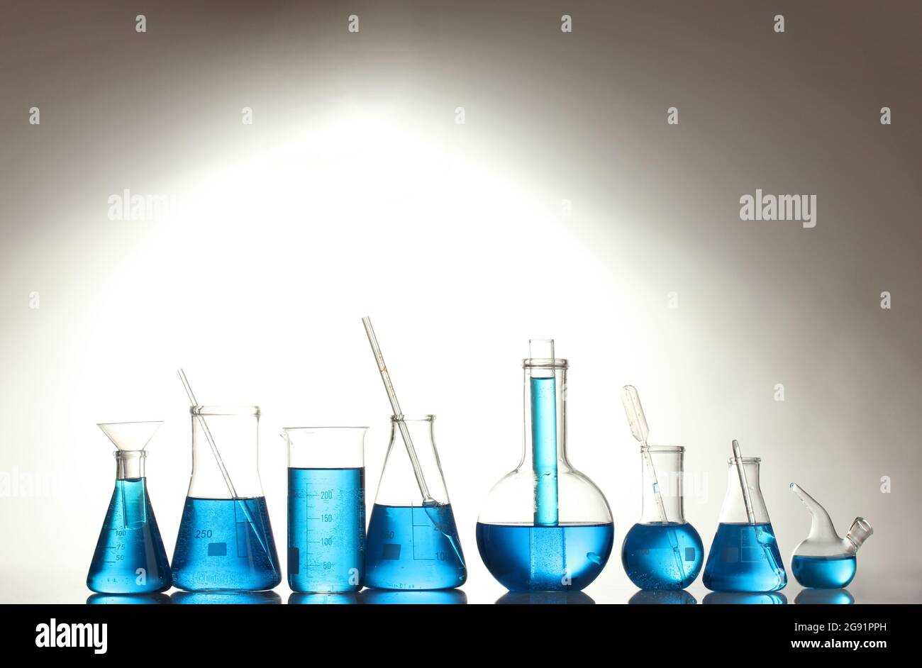 Test-tubes with blue liquid isolated on white Stock Photo - Alamy
