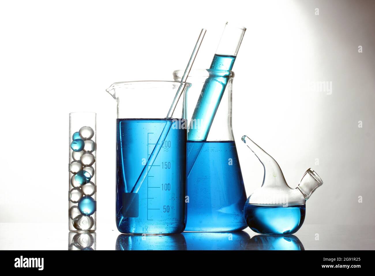 Test-tubes with blue liquid isolated on white Stock Photo - Alamy