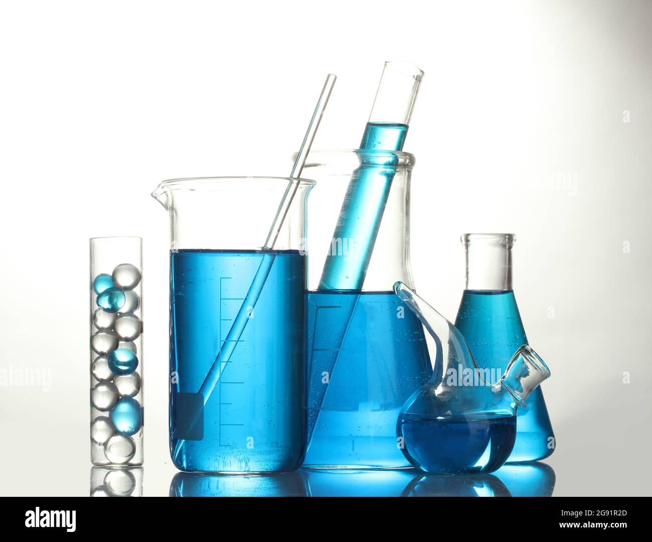 Test-tubes with blue liquid isolated on white Stock Photo - Alamy