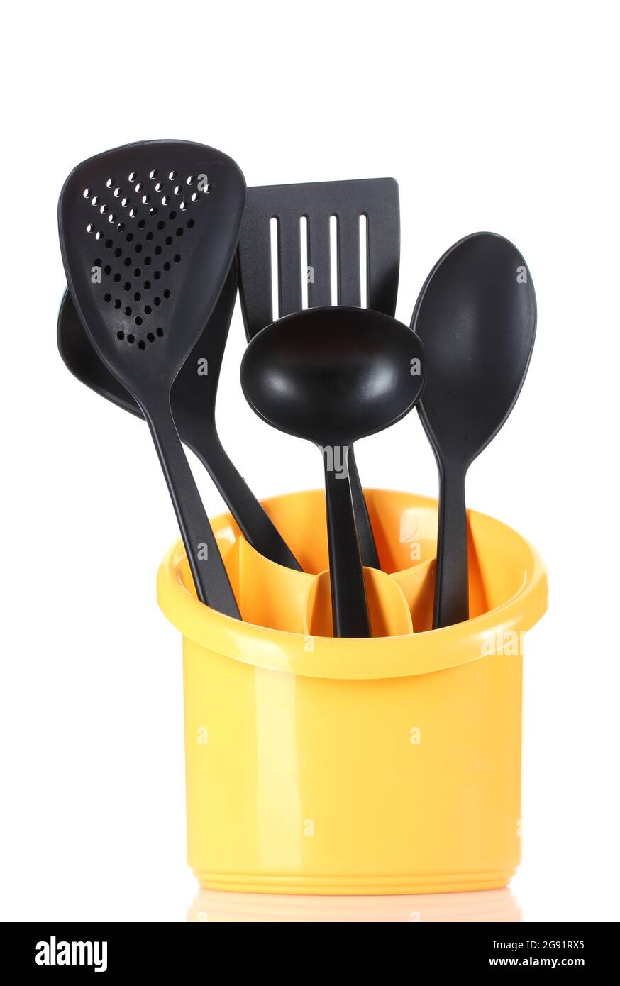 black kitchen utensils in yellow stand isolated on white Stock Photo