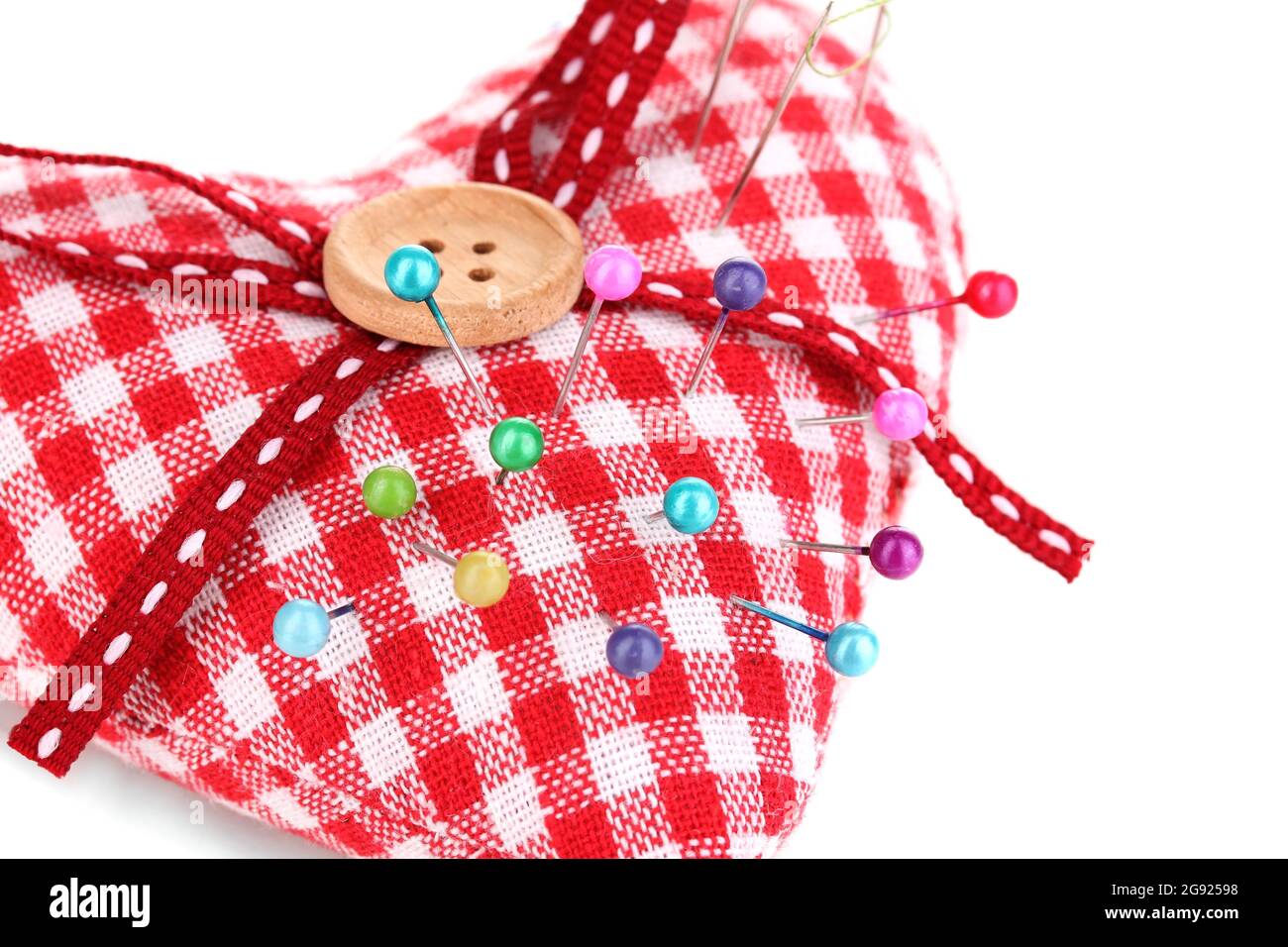 Colored pinheads in pincushion isolated on white Stock Photo Alamy