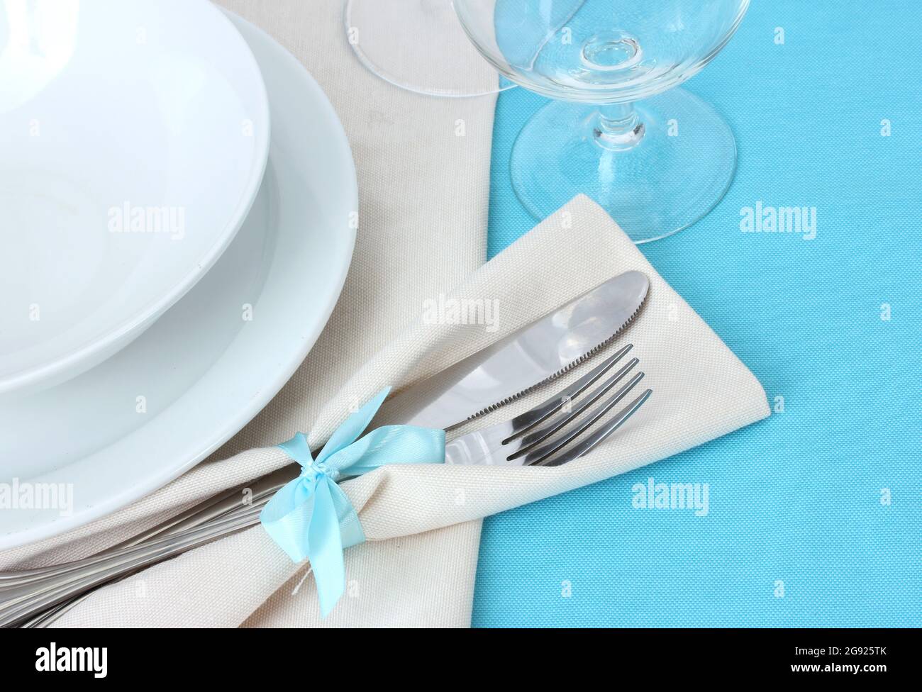 Table setting with fork, knife, plates, and napkin Stock Photo Alamy