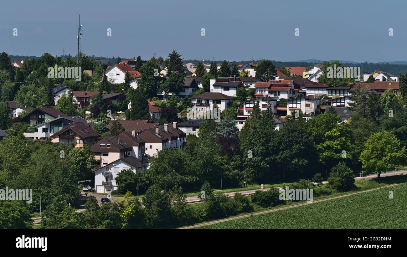 View of typical residential area in the west of village Beilstein in Baden-Württemberg, Germany on sunny summer day with country road and trees. Stock Photo