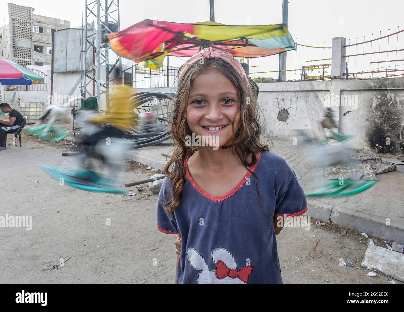 A Palestinian girl stands outside her house in the town of Beit Hanoun ...