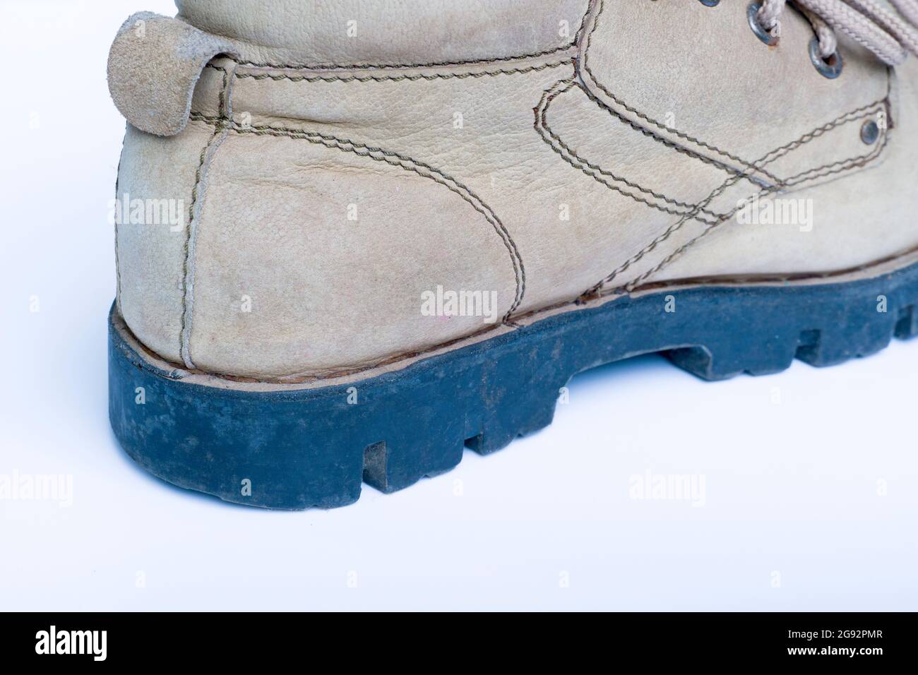 Brown leather boot used work shoe, closeup isolated on white background ...