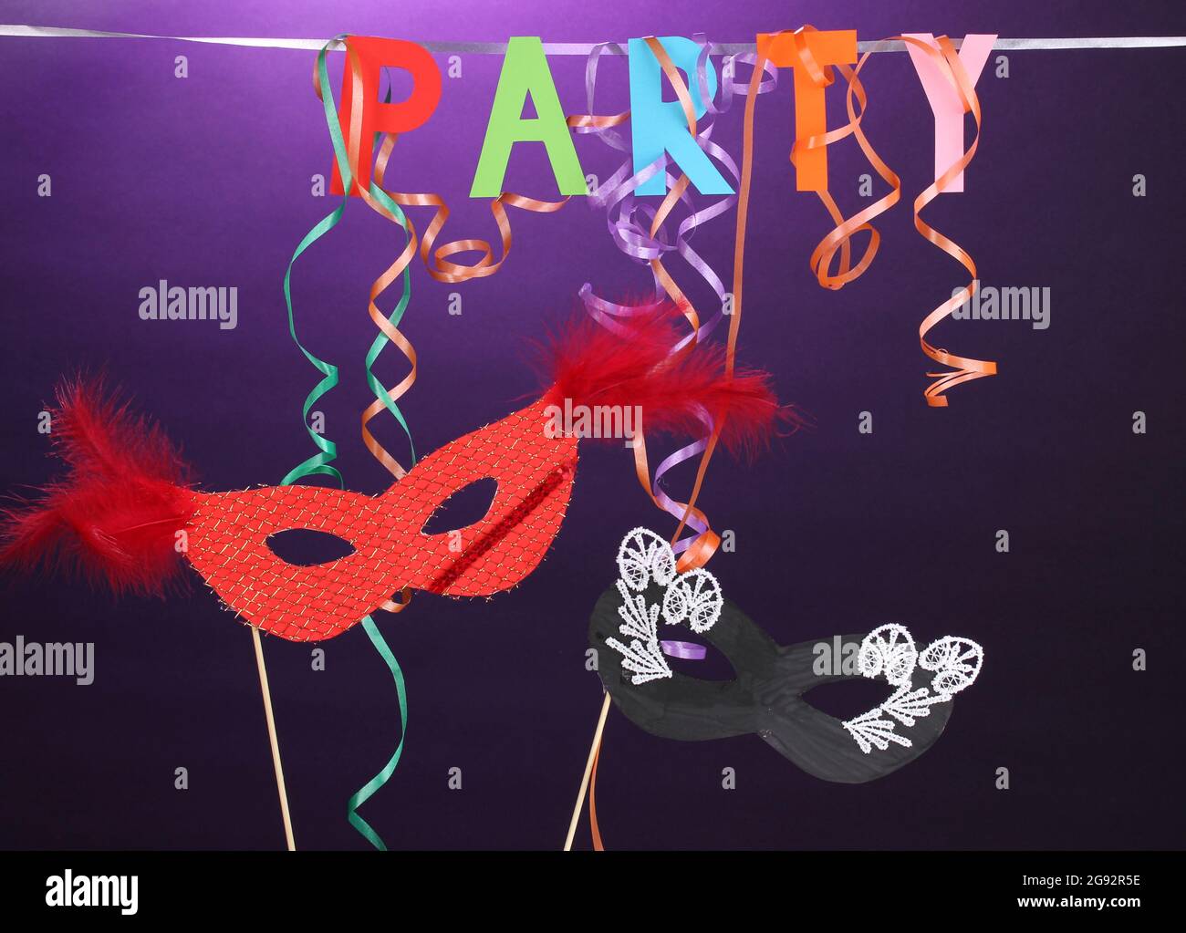 Party items on purple background Stock Photo Alamy