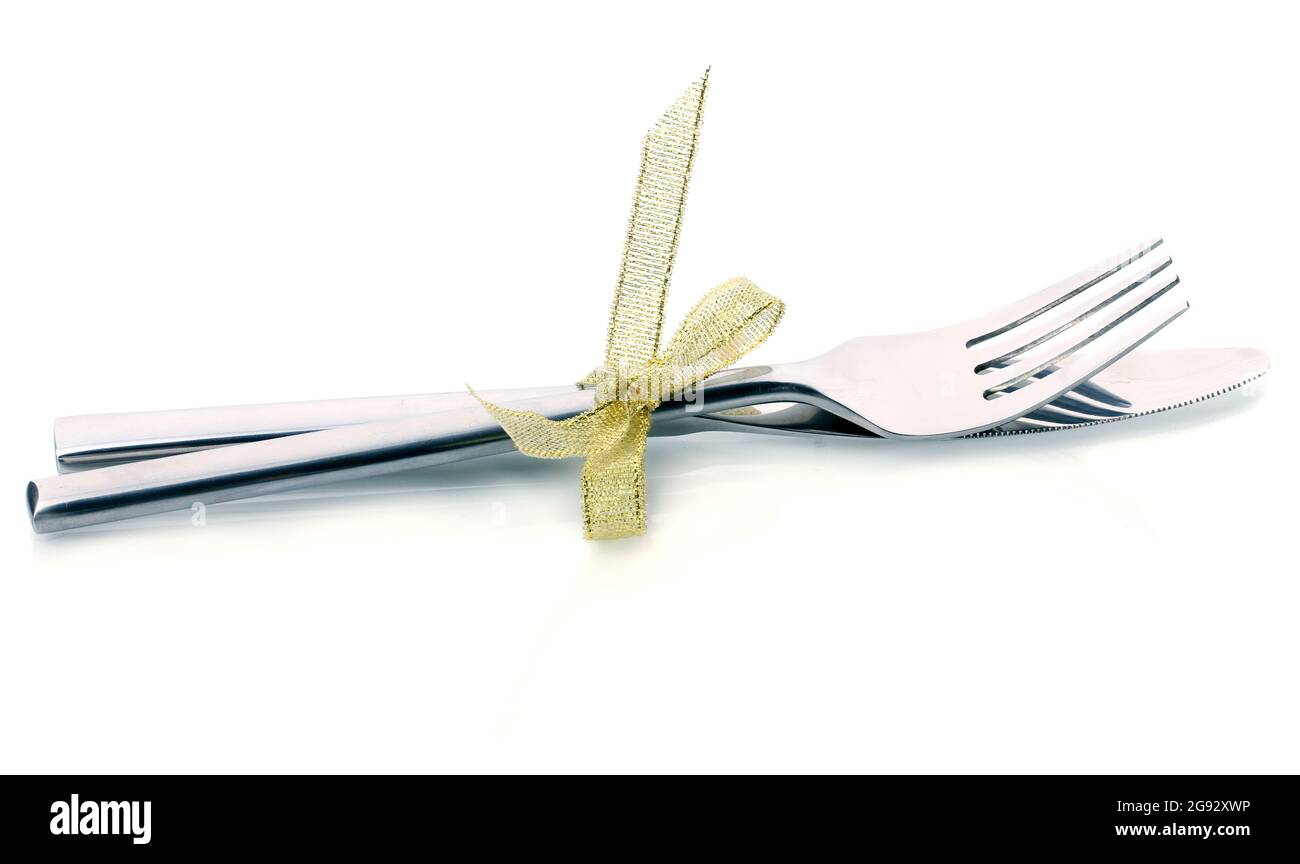 Silver fork and knife tied with ribbon isolated on white Stock Photo