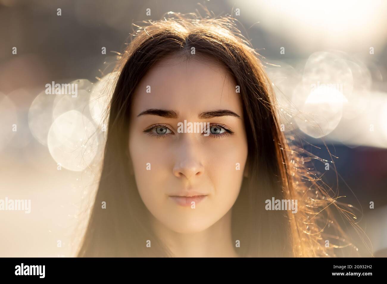 Serious woman with pensive look is posing outside for portrait. Stock Photo