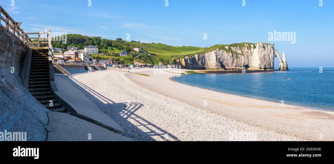 Panoramic view of the pebble beach of Etretat in Normandy with the ...