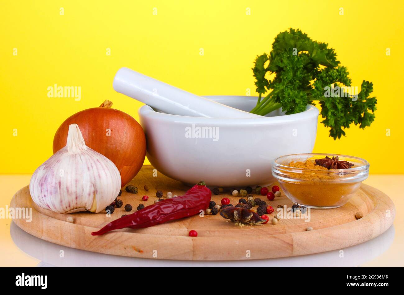 White mortar and pestle with spice on yellow background Stock Photo Alamy