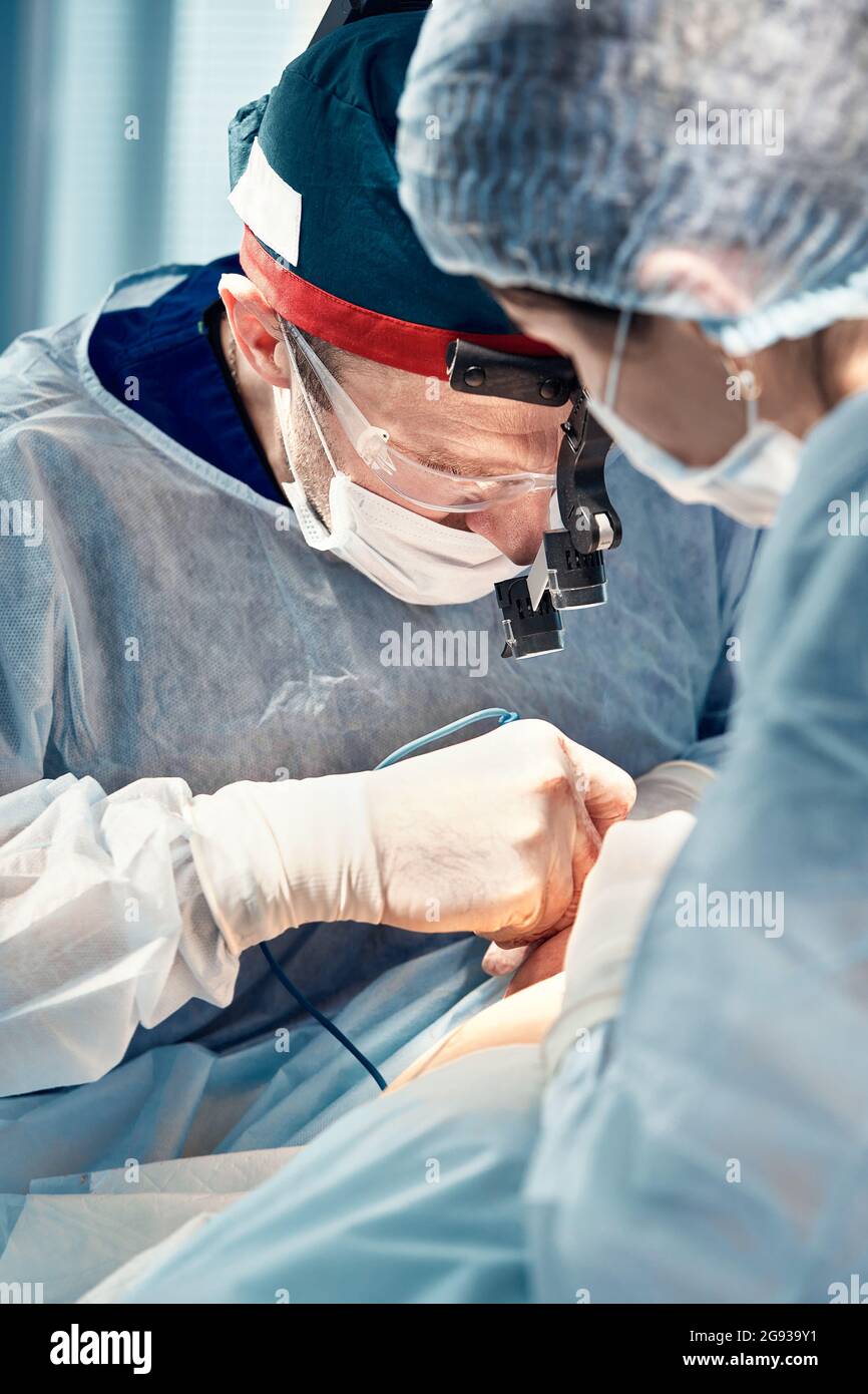 Blepharoplasty, professional surgeons during eye plastic surgery, facial rejuvenation