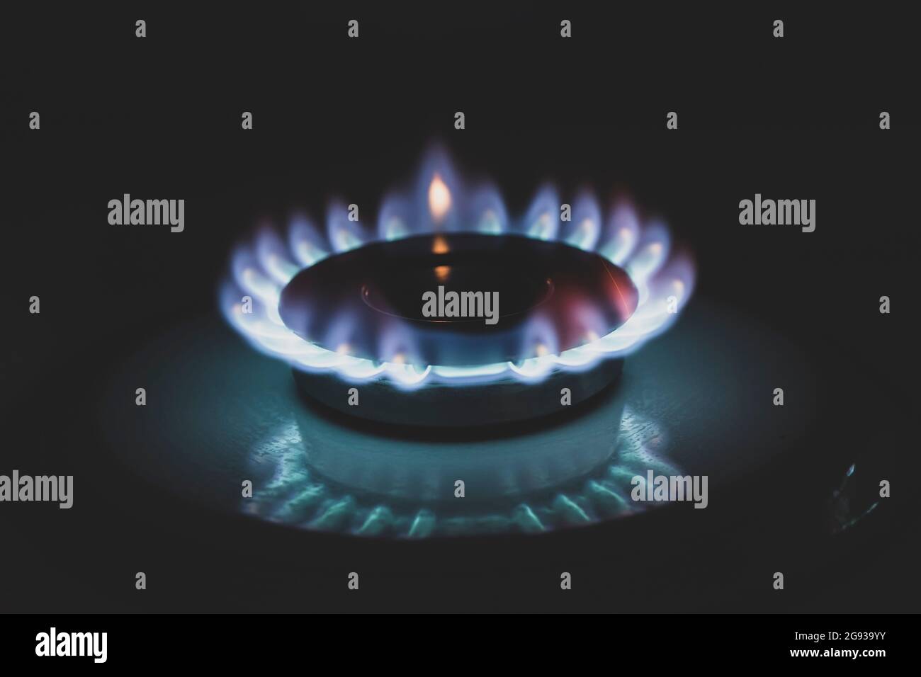 Blue propane gas burns on the kitchen gas stove. Selective focus