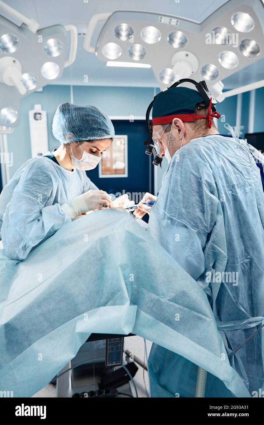 Blepharoplasty, professional surgeons during eye plastic surgery, facial rejuvenation