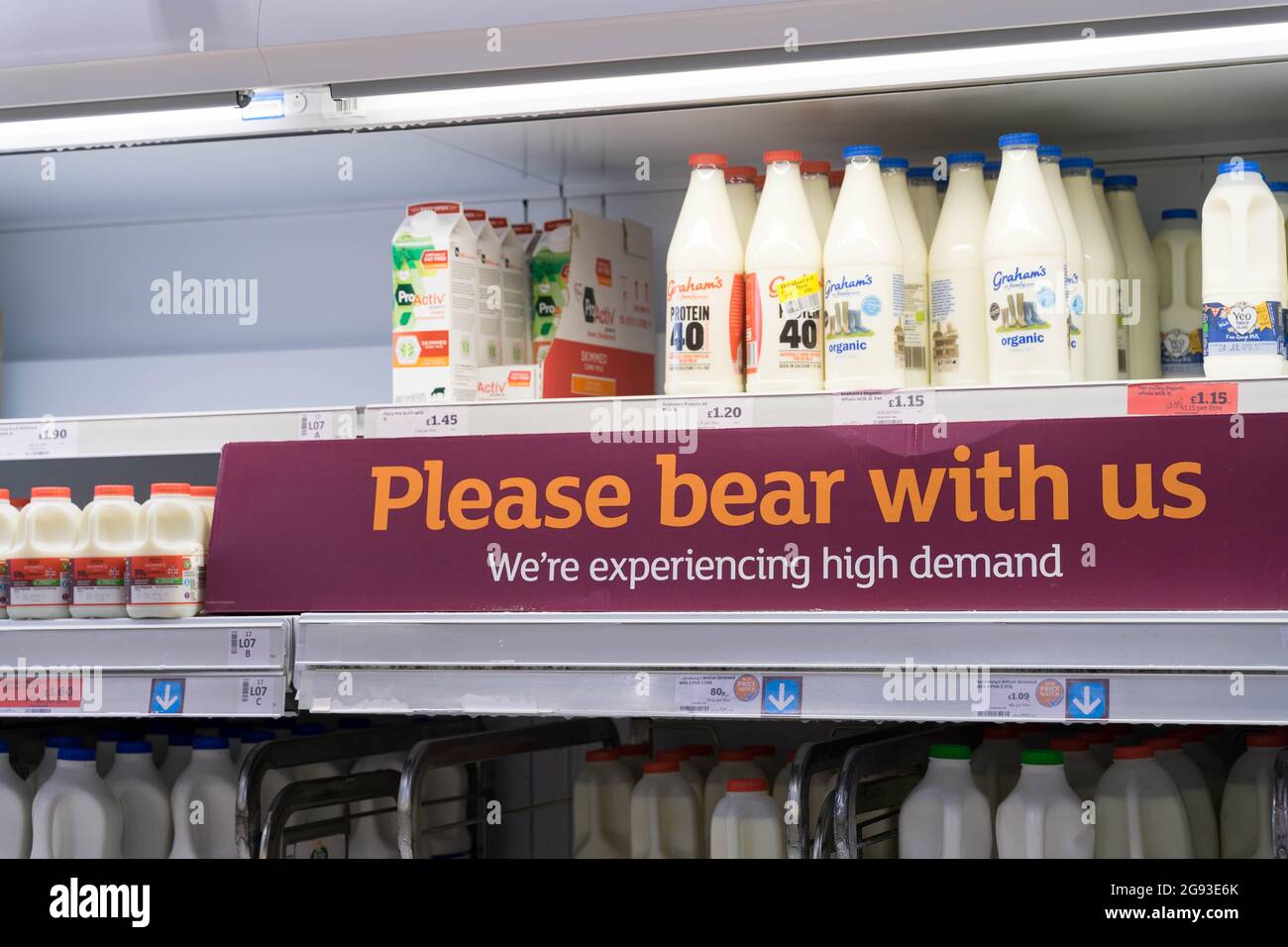 Empty shelves at Sainsbury's supermarket, showing message "Please bear
