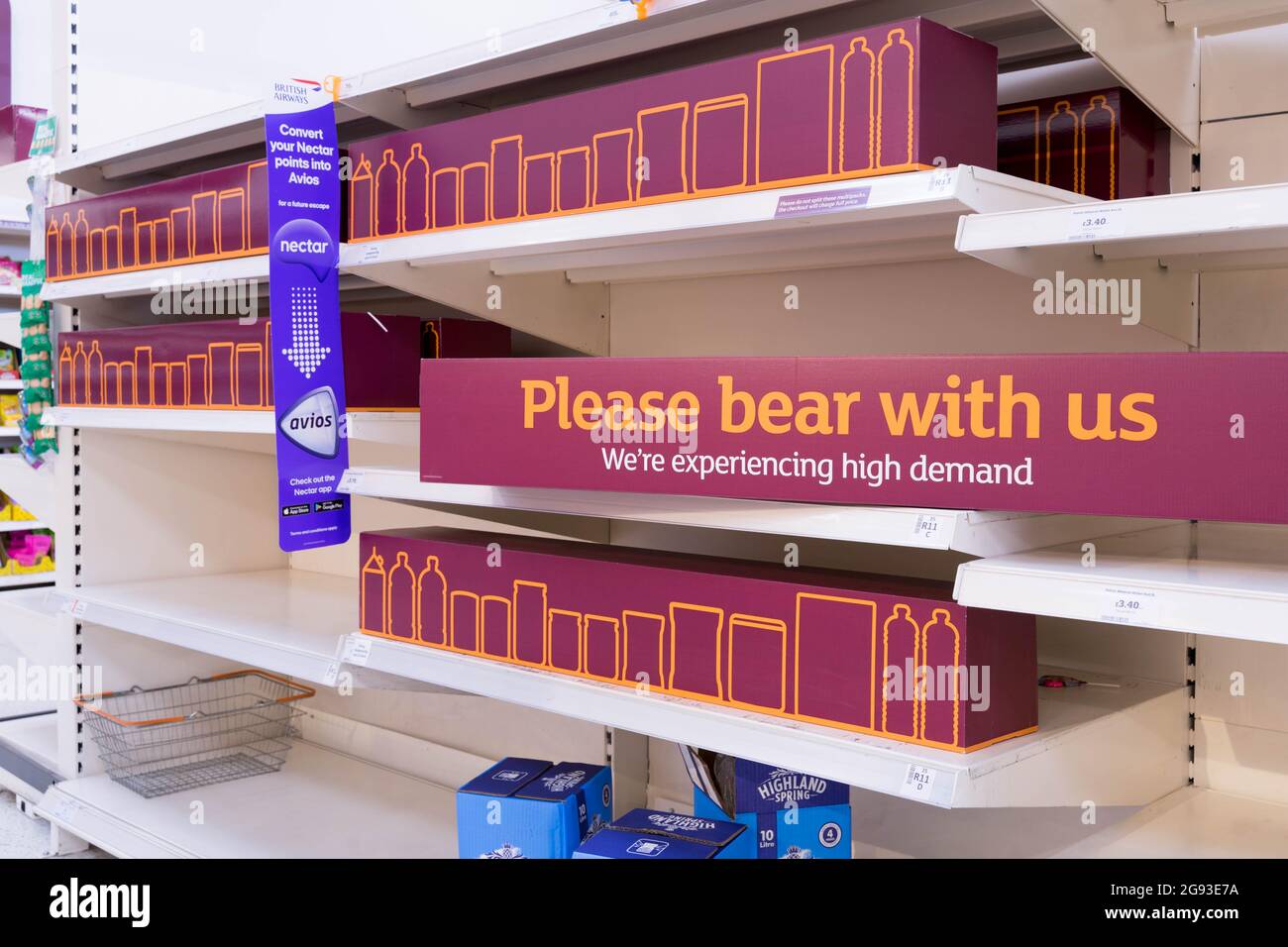 due to shortage of staffs and food supplies, shelves at supermarket Sainsbury's displaying 'please bear with us' and replaced with empty cartoon box Stock Photo