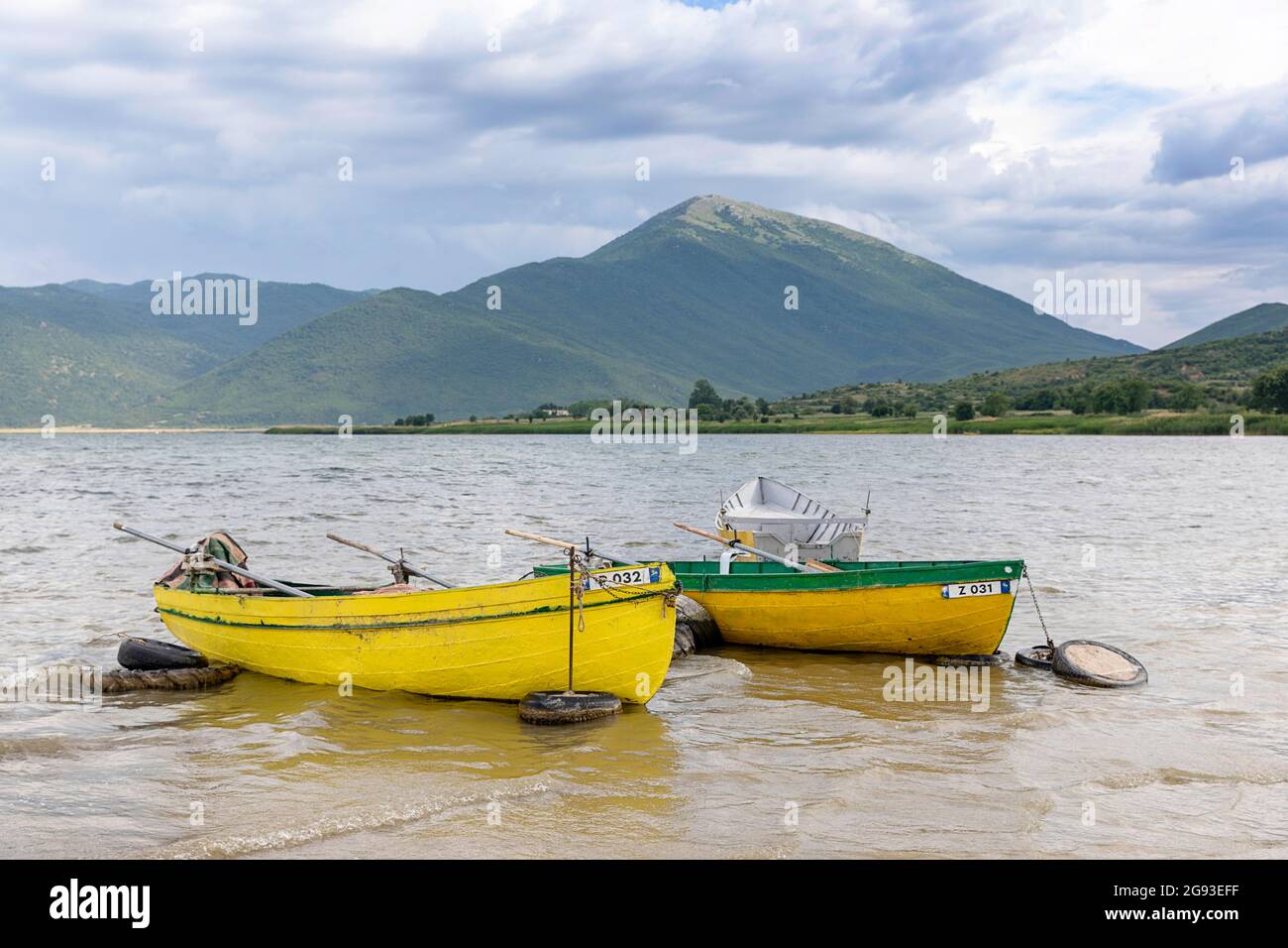 Colourful traditional wooden fishing boats on Lake Prespa in Albania Stock Photo