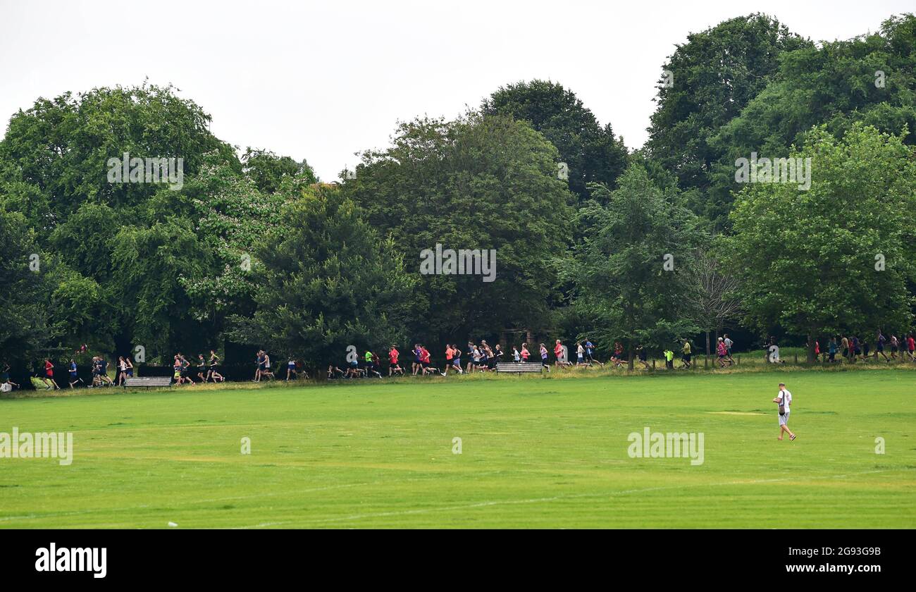 Brighton UK 24th July 2021 - Hundreds of runners take part in the Parkrun held in Preston Park Brighton this morning . Park Runs have resumed today for the first time after COVID-19 restrictions were eased throughout England this week : Credit Simon Dack / Alamy Live News Stock Photo