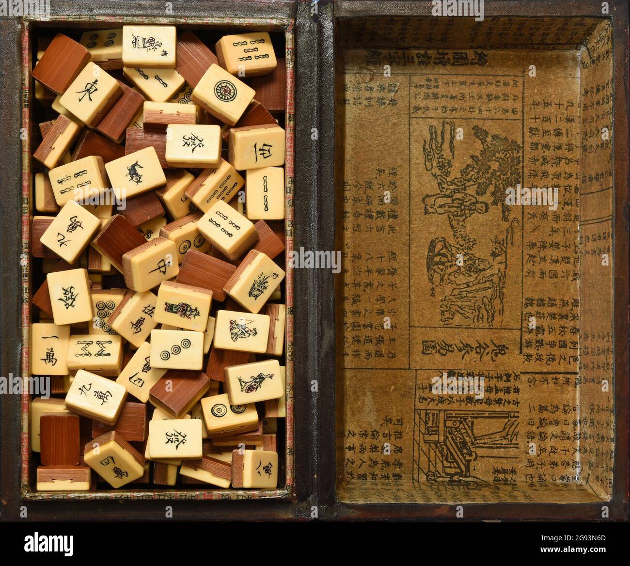 Vintage Bone and bamboo  Mahjong or mah-jongg playing tiles in box. Background. Stock Photo