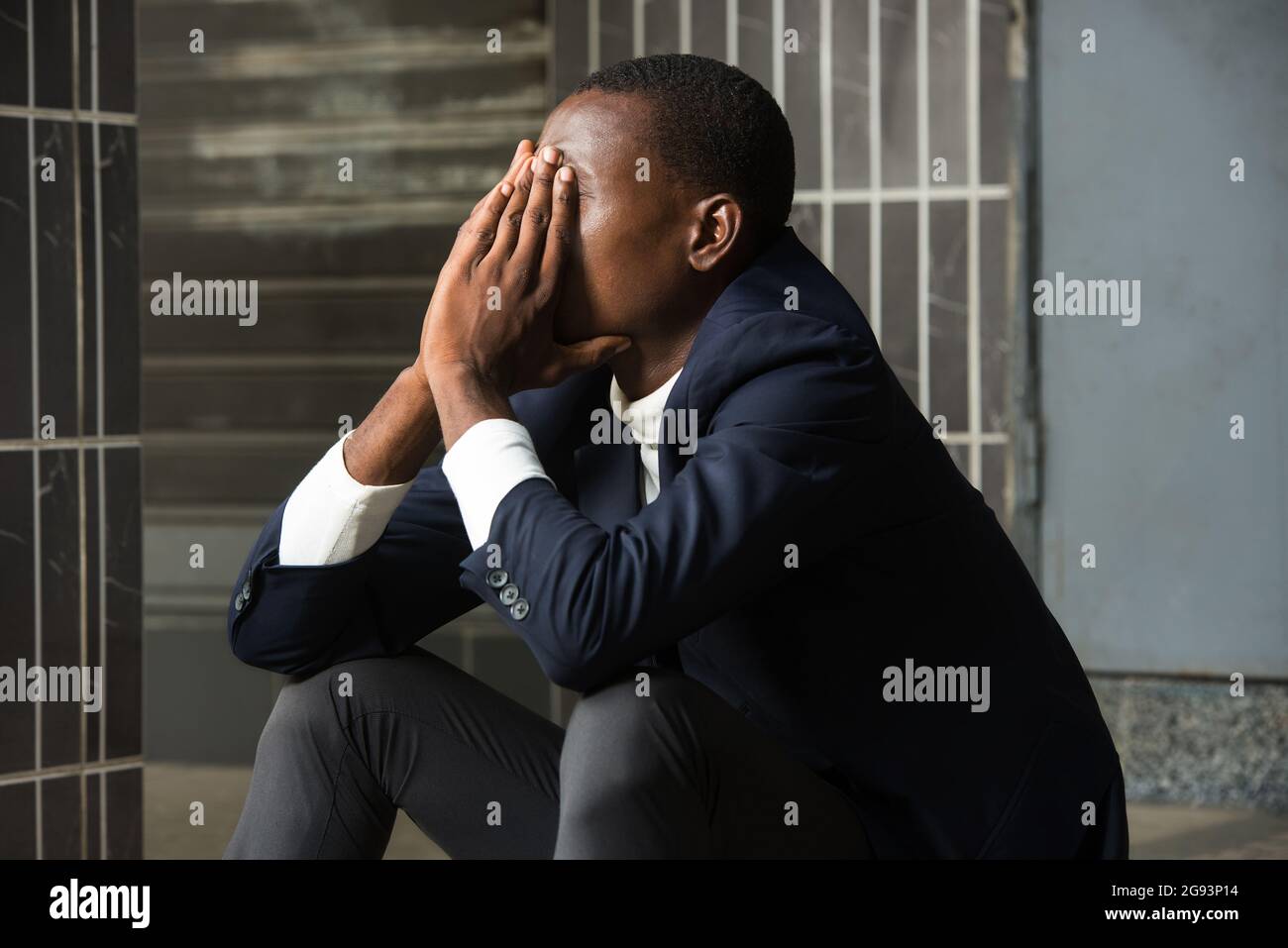young man in suit sitting out depressed sad crying devastated ...