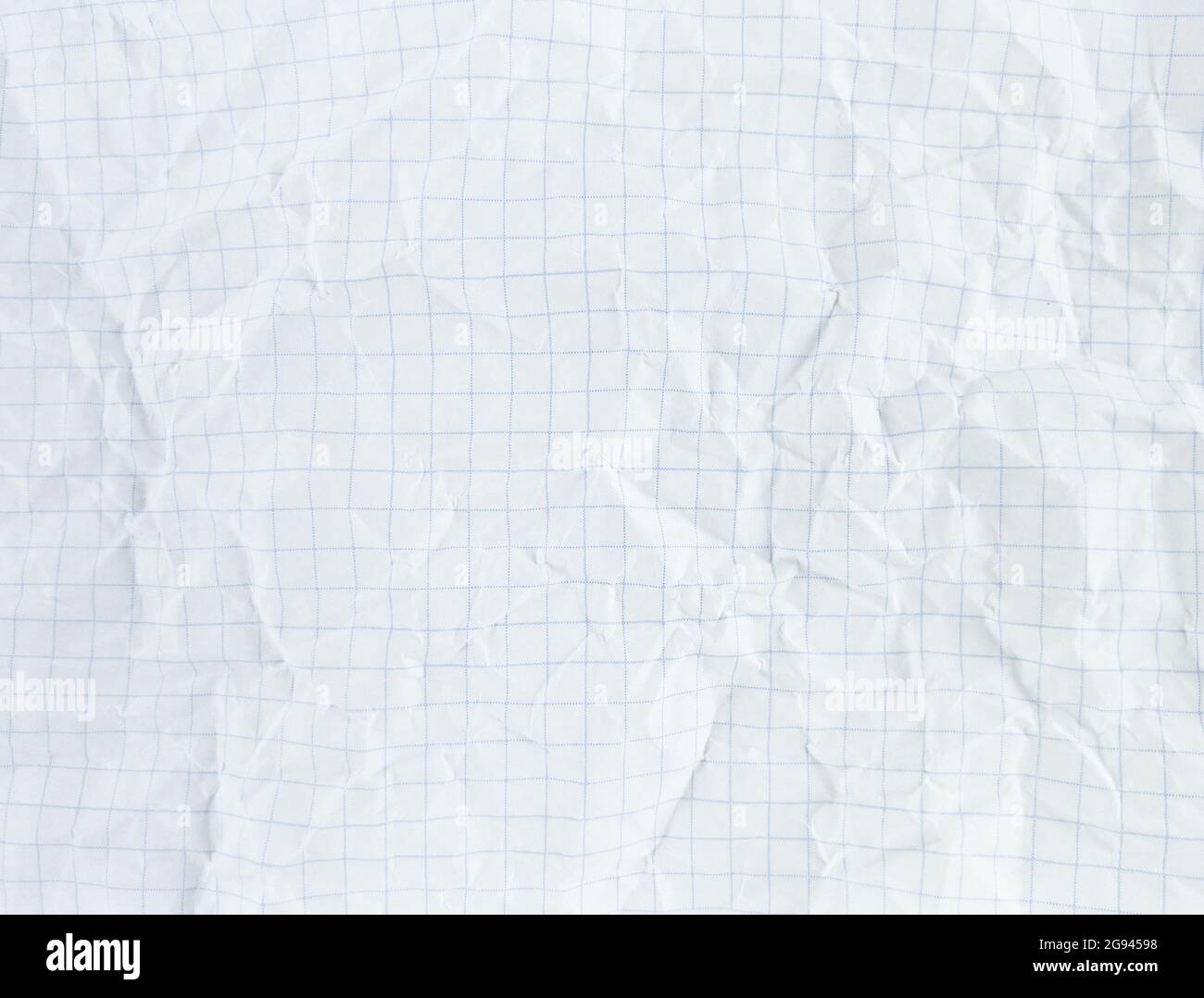 Crumpled white sectional paper sheet textured with empty space. Stock Photo