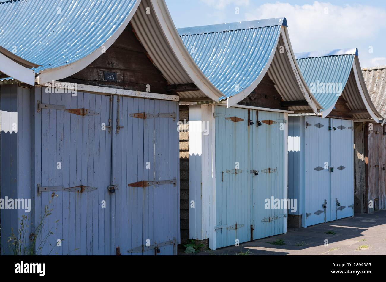 Landscape view of beach huts with curved roofs and painted in pastel colours, Sutton-on-Sea, Lincolnshire,UK, June Stock Photo