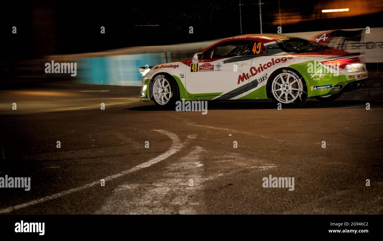 Alpine A110 rally car runs at night at stage SSS0 during Rally di Roma Capitale near Terme di Caracalla, Rome, Italy Stock Photo