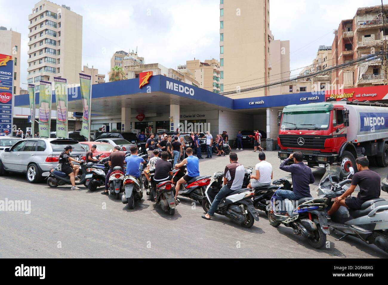 Beirut, Lebanon. 23rd July, 2021. Clients queue at a petrol station in Beirut, Lebanon, on July 23, 2021.Due to the lack of fuel, petrol stations in Lebanon currently can't serve the needs of all customers and people use to sleep at night in their cars waiting for the opening of stations. According the newspaper L'orient le jour, in the night between July 23 and 24 a truck hit some cars queueing at a petrol station in Beirut, killing a person and injurying three others. (Photo by Elisa Gestri/Sipa USA) Credit: Sipa USA/Alamy Live News Stock Photo