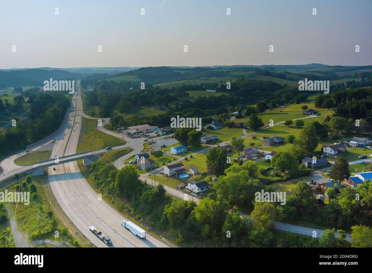 A small Bentleyville town village behind trees and hills the farm