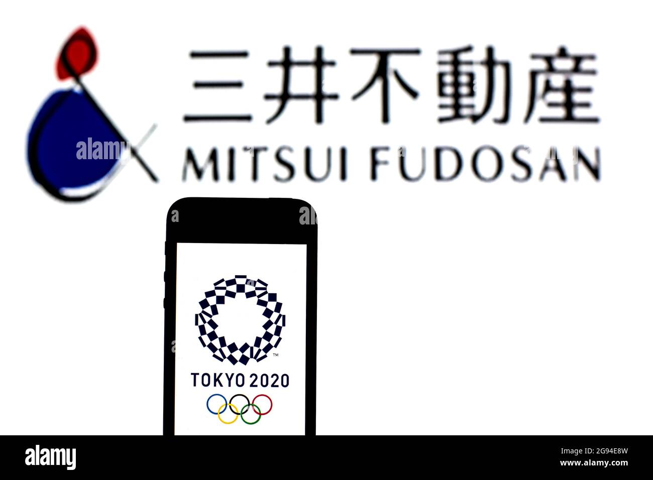 In this photo illustration a Tokyo 2020 Olympic Games logo seen displayed on a smartphone with a Mitsui Fudosan Co, Ltd logo in the background. Stock Photo