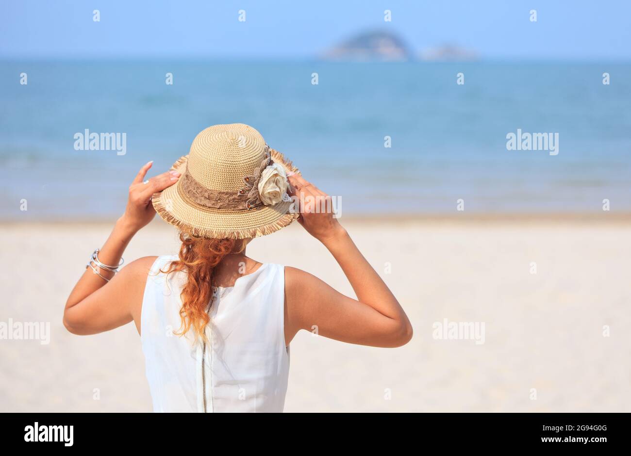Woman standing looking at sea hi-res stock photography and images - Alamy