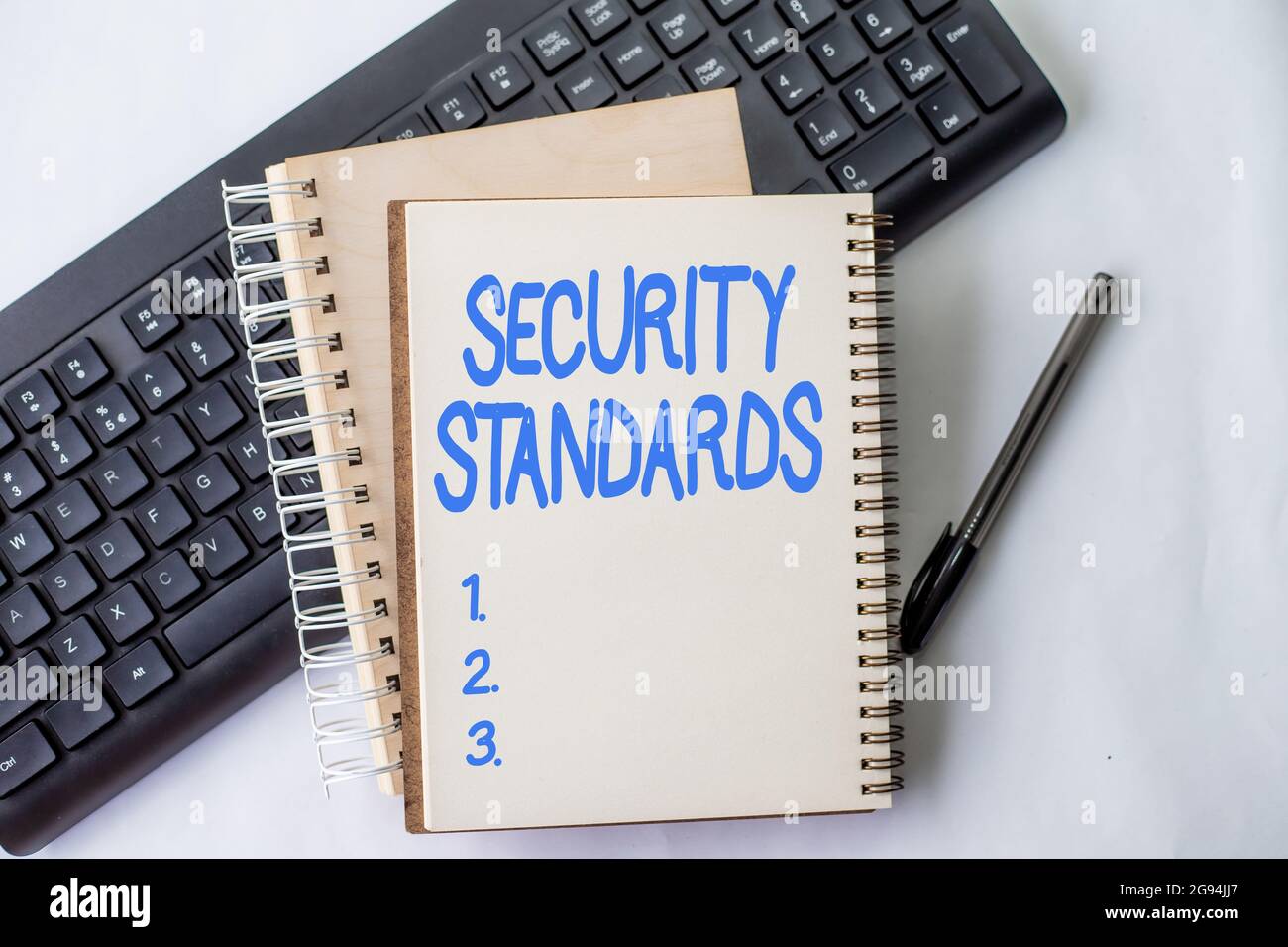Text showing inspiration Security Standards. Word for the scope of security functions and features needed Two Plain Lined Spiral Notebooks With Pen Stock Photo