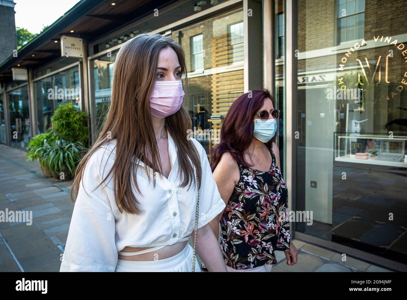United Kingdom / London /Two female shoppers from Germany wearing a mask near King's Rd, London , United Kingdom. Stock Photo