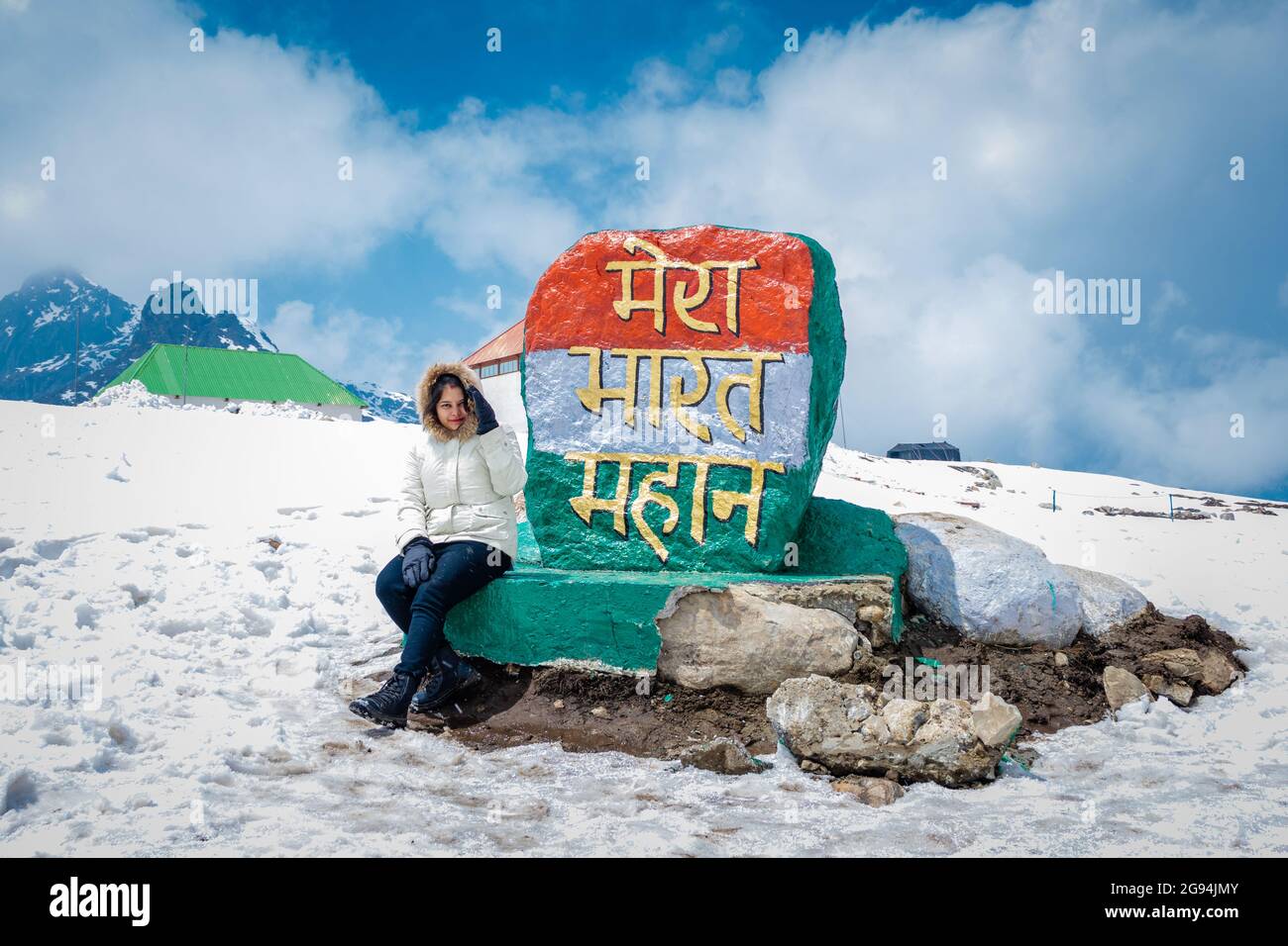 young girl isolated at indian tricolor milestone board image is taken at bumla pass arunachal pradesh india. Stock Photo