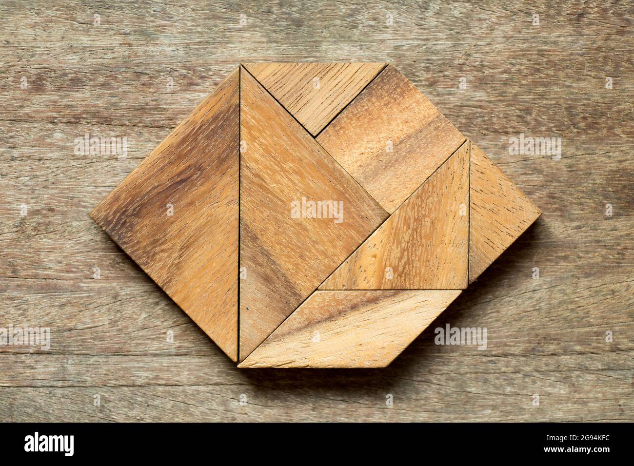 Tangram puzzle in hexagon shape on wood background Stock Photo - Alamy