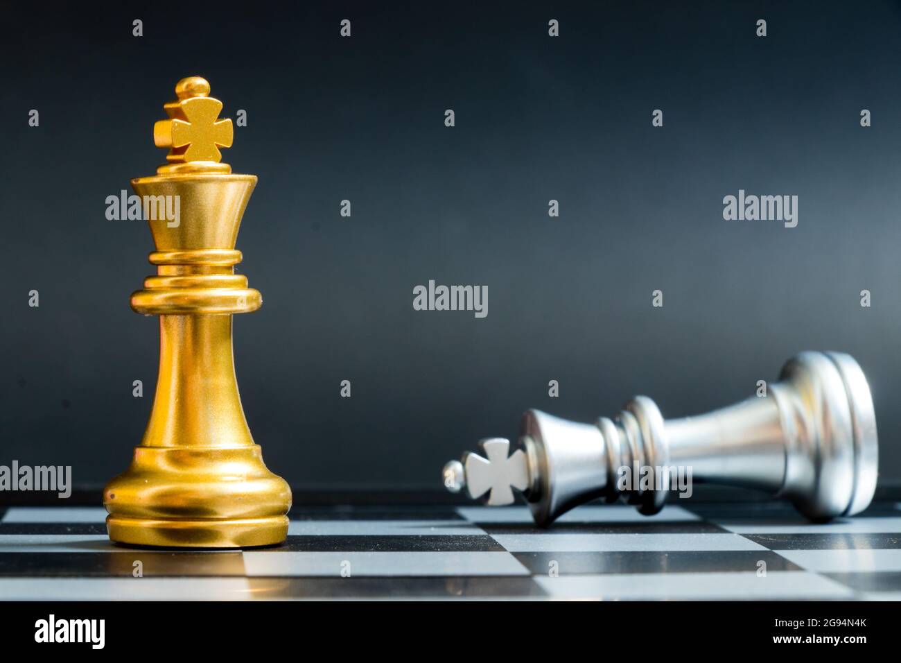 Premium Photo  Golden king chess standing with chess pieces lying