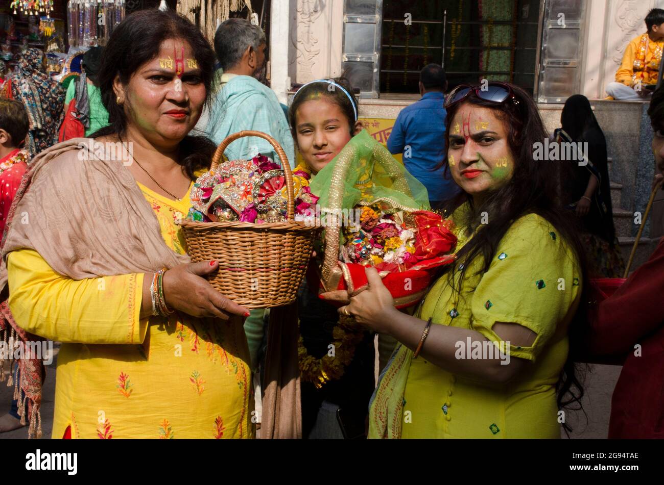 Devotees are holding the deity of lord Krishna. Stock Photo
